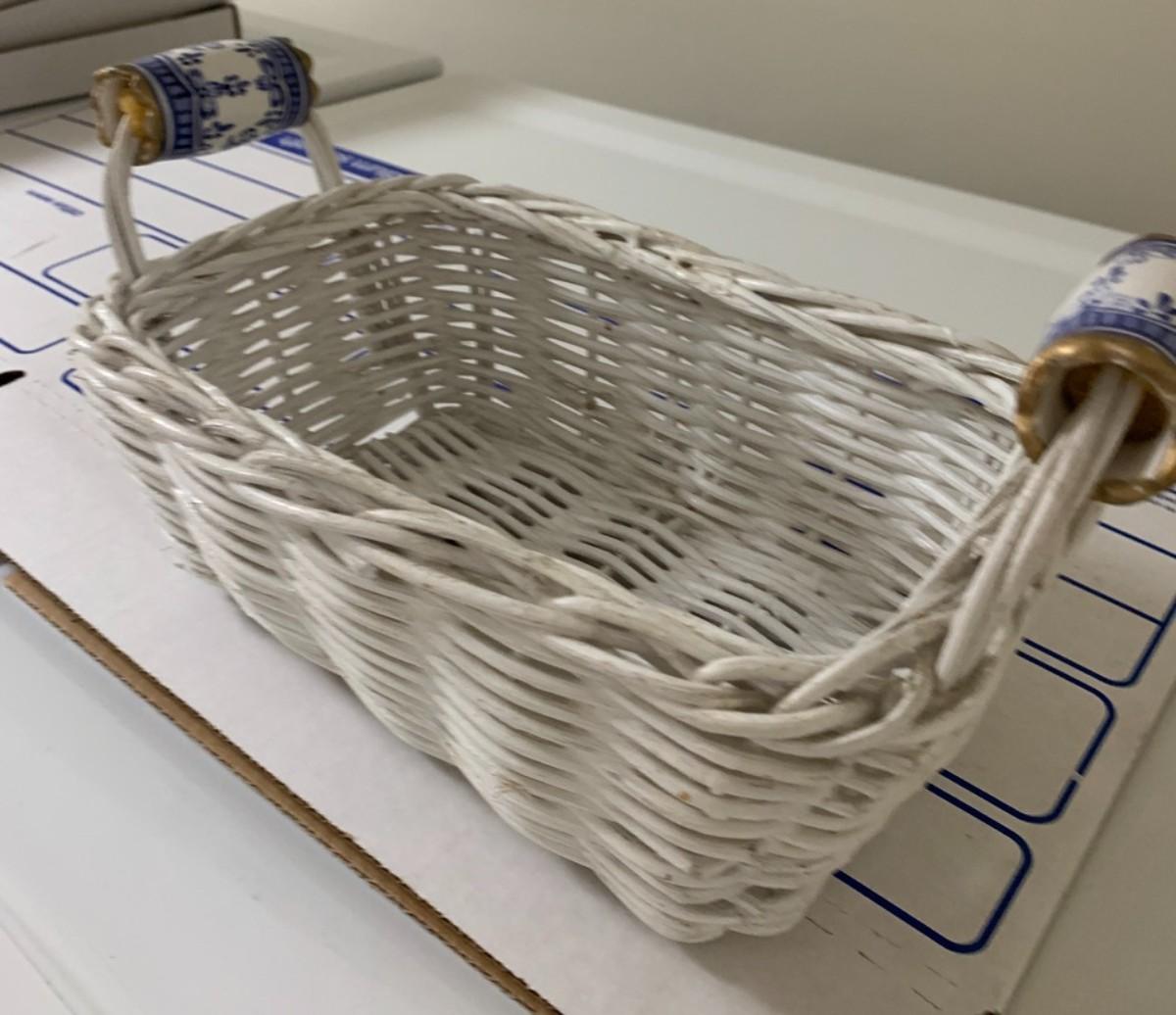 White wicker basket with ceramic blue handles