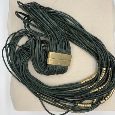 Multi-strand green necklace with gold-colored beads