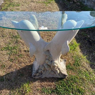 A dolphin base Accent Table