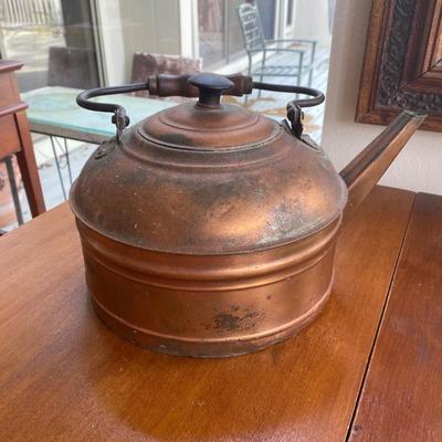 Antique copper kettle with wooden handle