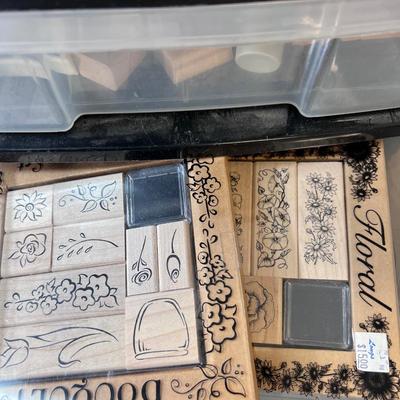 Hundreds of un used rubber stamps, many in sets in a rolling six drawer storage chest 16 X 16 X 31