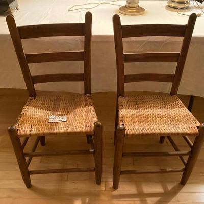 Two antique ladder back mission chairs with woven seat