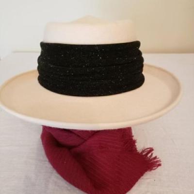 Women's cream colored fedora hat with a black ribbon and bow