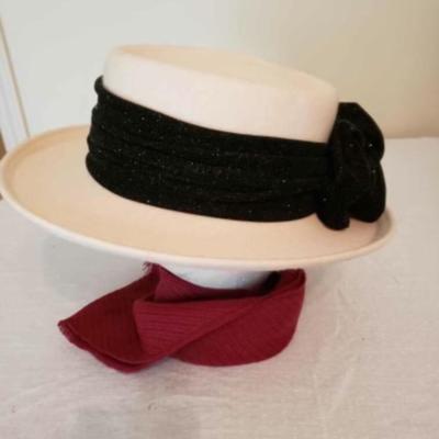 Women's cream colored fedora hat with a black ribbon and bow