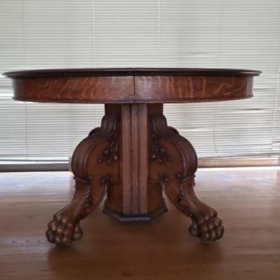Antique oak pedestal dining tableÂ with large carved lion paw feet, 2 leaves