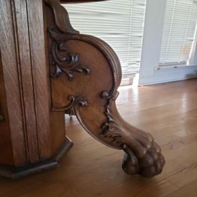 Antique oak pedestal dining tableÂ with large carved lion paw feet, 2 leaves