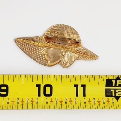 VINTAGE FAUX GOLD TONED WOMAN W/ LARGE HAT PIN