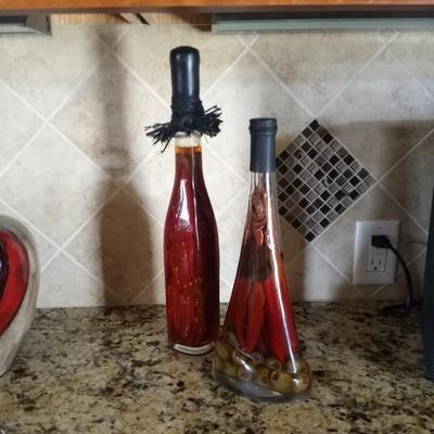 CERAMIC JAR AND TWO GLASS BOTTLES FILLED WITH PEPPERS