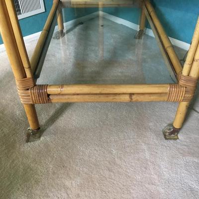 Vintage bamboo bar cart with wheels and removable tray.