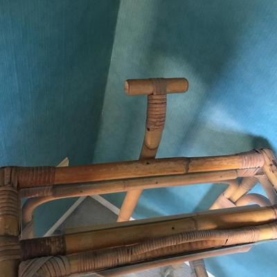 Vintage bamboo bar cart with wheels and removable tray.