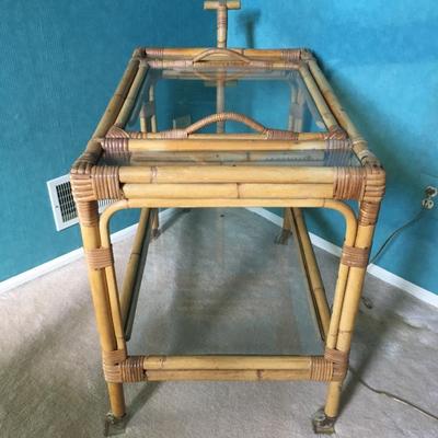 Vintage bamboo bar cart with wheels and removable tray.