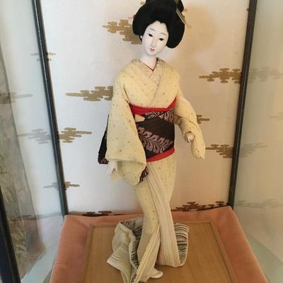 Geisha doll in glass case