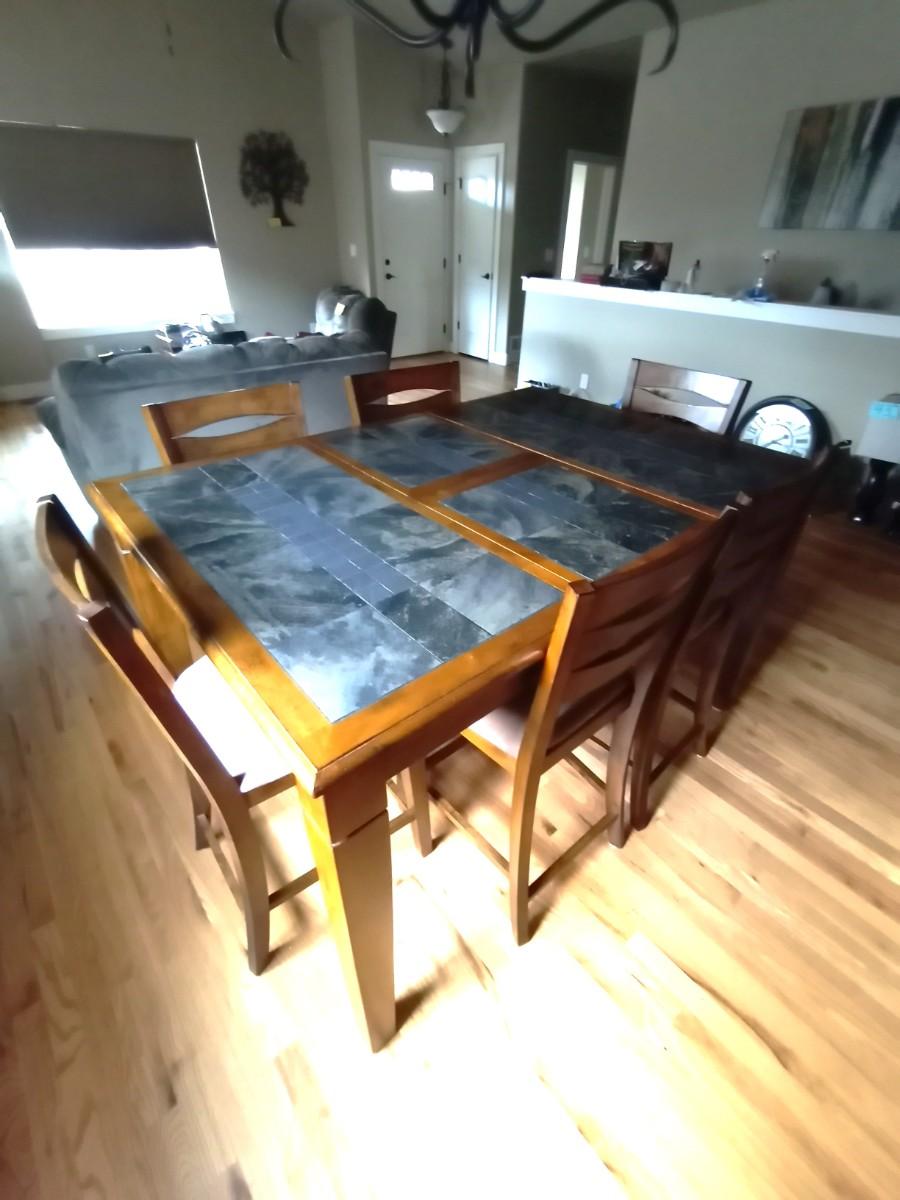 COUNTER HEIGHT WOODEN TABLE WITH TILE TOP AND SIX CHAIRS