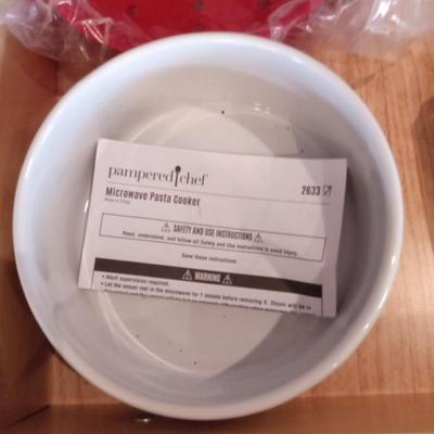 PAMPERED CHEF KITCHEN ITEMS AND A SIGN