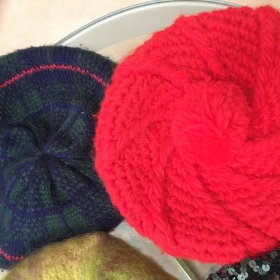 Knit berets some with pom poms