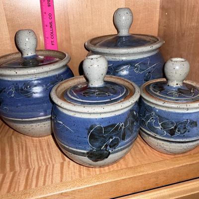 Four Pottery Stoneware Containers with lids.  Signed