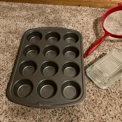 Cupcake pan, two strainers , platter and butter dish.