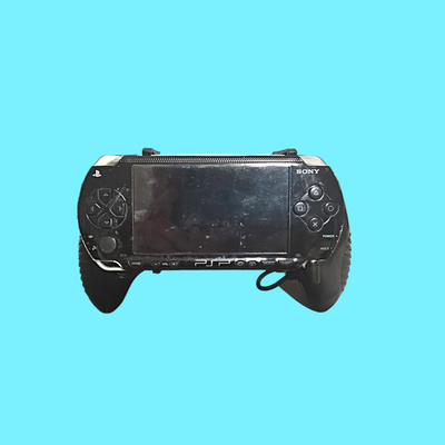 Playstation P2P Portalble Handheld Game System (used) w/ Datel Power Grips & 4 Games
