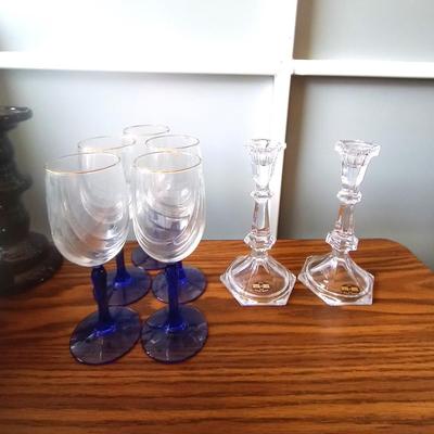BLUE GLASS STEMMED DRINKING GLASSES AND CRYSTAL CANDLE HOLDERS