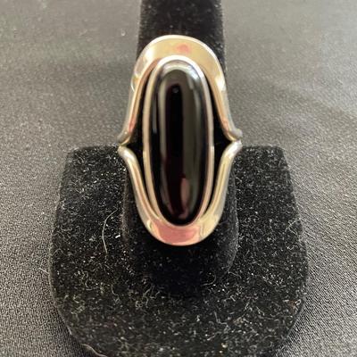 STERLING SILVER RING WITH AN OVAL BLACK STONE
