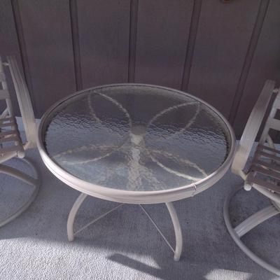 Three Piece Patio Set includes Two Swivel Chairs with Cushions and Round Table