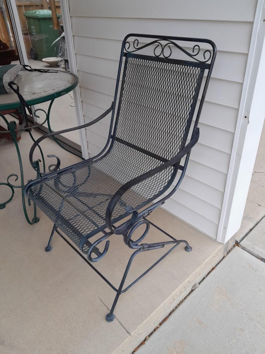 Metal Patio chair with tall tempered glass topped table.