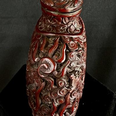 Intricately Carved Snake in a Garden Deep Reddish Brown Snuff Bottle