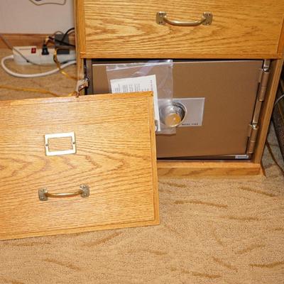 OAK TWO DRAWER FILE CABINET W/ CONCEALED SAFE BELOW.