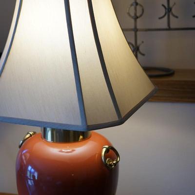 MODERN STYLE ASIAN PORCELAIN TABLE LAMPS IN RUST ORANGE TONES, BRASS RINGS AND PLATEAUS.