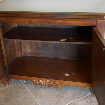 MODERN ASIAN STYLE TWO DOOR WOOD CABINET WITH BRASS PEDAL PULLS.