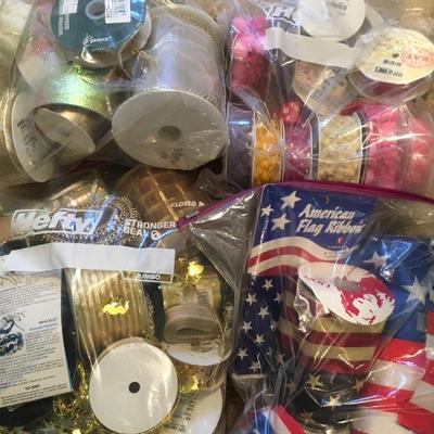 Bundles of assorted ribbons including red, white and blue