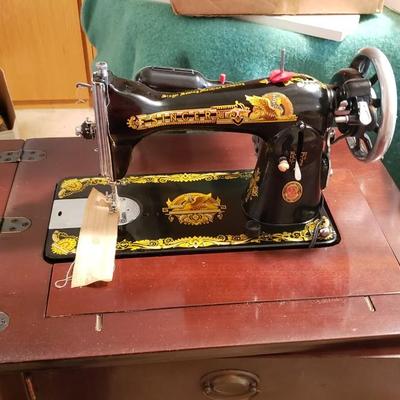 Singer Golden Sphinx sewing machine in cabinet