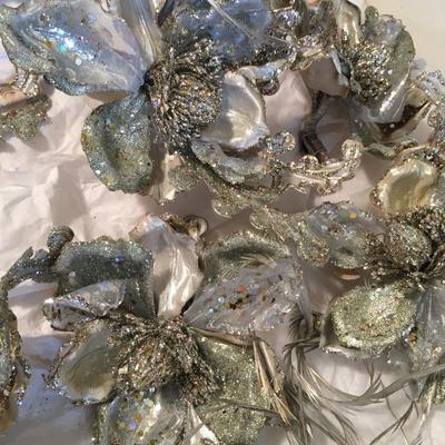 12 silver floral decorations with feather accents