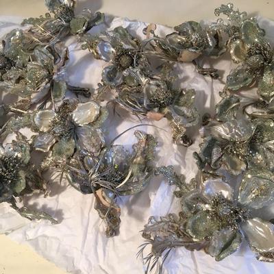12 silver floral decorations with feather accents