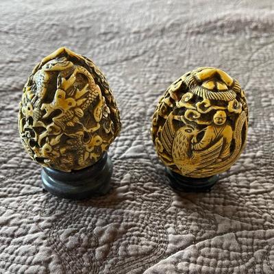 2- egg shaped carved pieces.