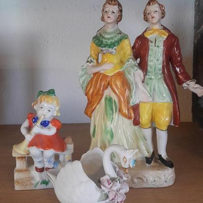 PORCELAIN FIGURES MAN, WOMAN, LITTLE GIRL AND A SWAN