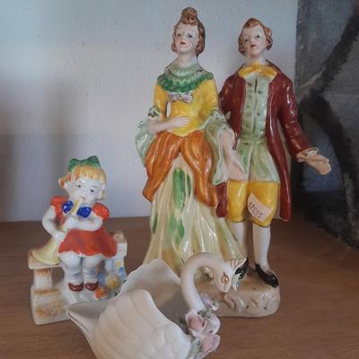 PORCELAIN FIGURES MAN, WOMAN, LITTLE GIRL AND A SWAN