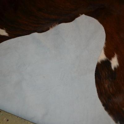 LOT 470. COWHIDE RUG