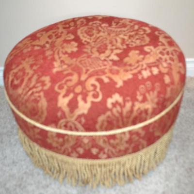 LOT 535. RED AND GOLD ROUND OTTOMAN BY JENNIFER TAYLOR