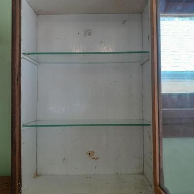 Antique wooden medicine cabinet with glass shelves