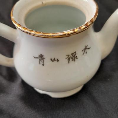 Collection of small porcelain bowls, tea pot, and mug