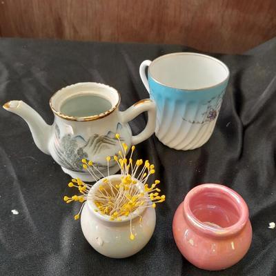 Collection of small porcelain bowls, tea pot, and mug