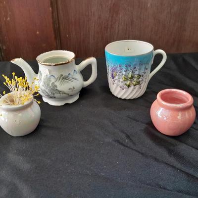 Collection of small porcelain bowls, tea pot, and mug
