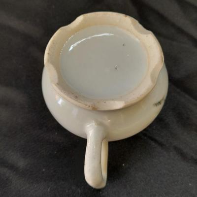 Collection of small porcelain bowls, tea pot, and mug