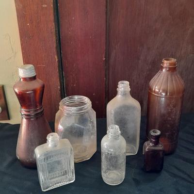 Seven Old glass bottles and jars