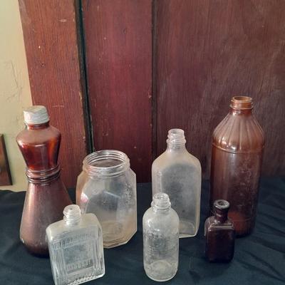 Seven Old glass bottles and jars