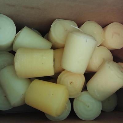 Assorted candles and holders including vintage wooden spool