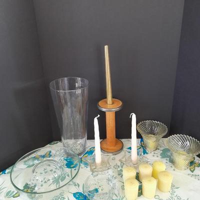 Assorted candles and holders including vintage wooden spool