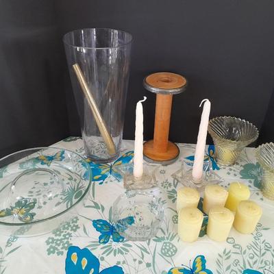 Assorted candles and holders including vintage wooden spool
