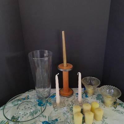Assorted candles and holders including vintage wooden spool